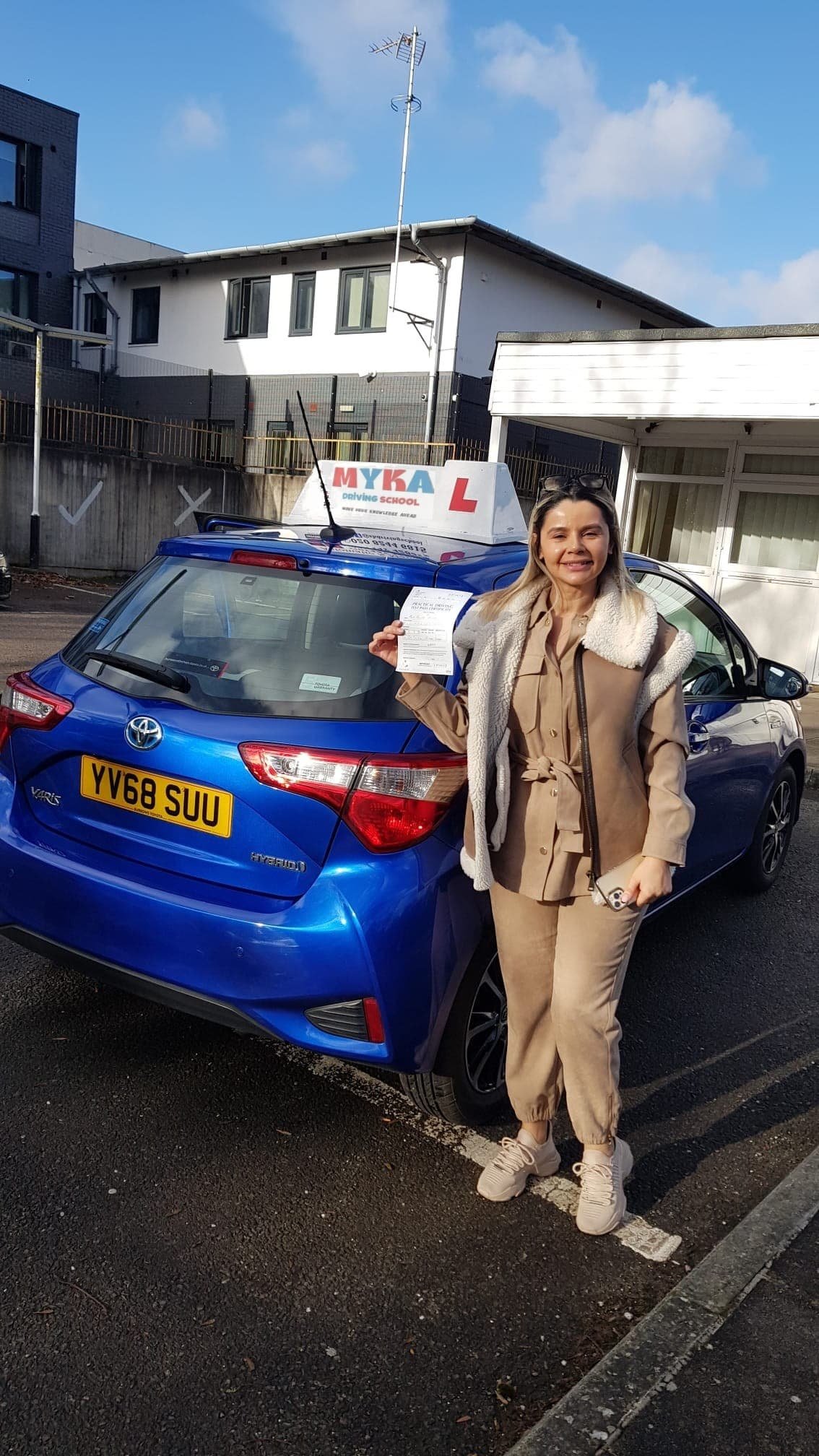 a woman standing next to a car